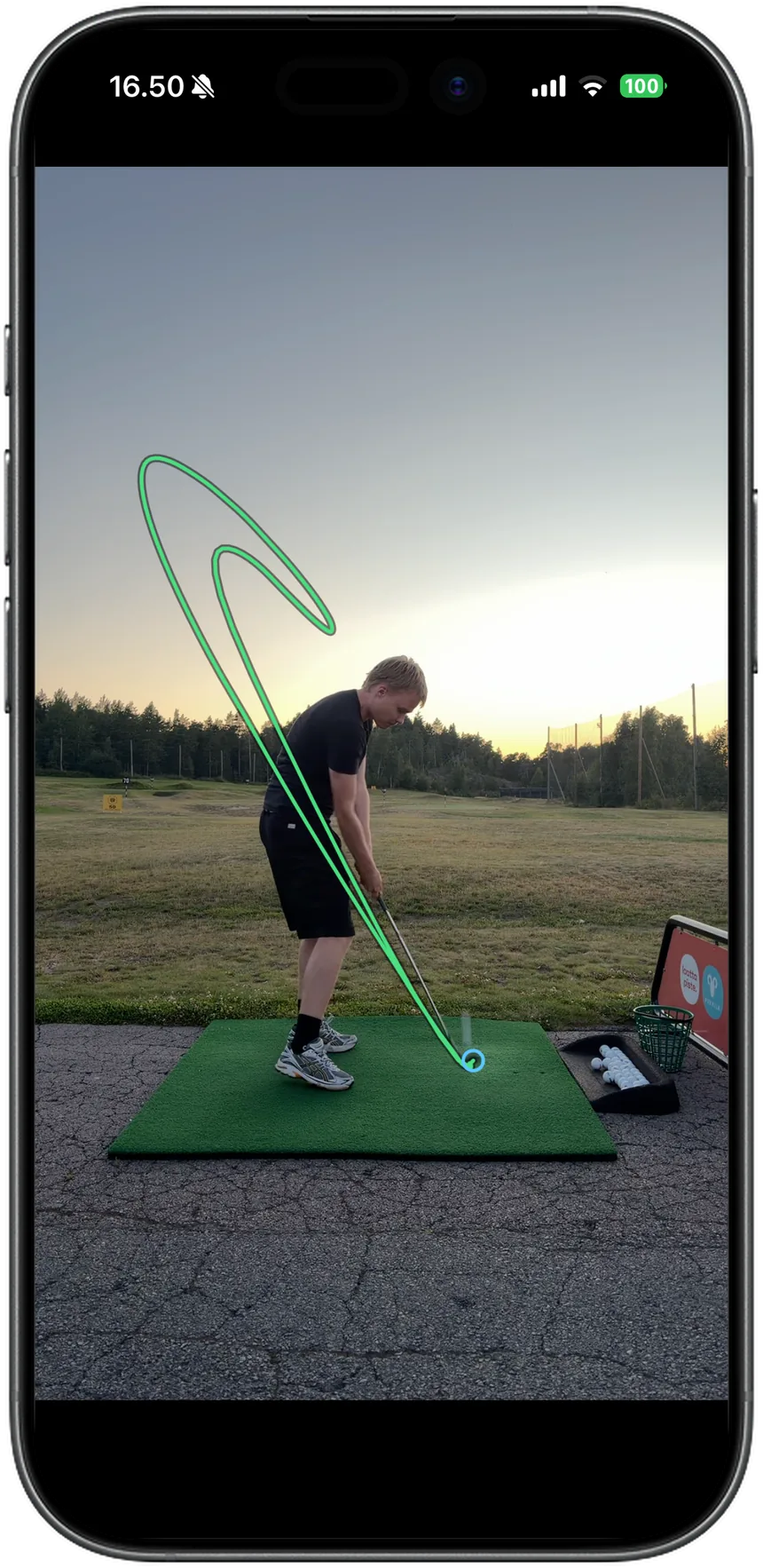 Club path traced in green over a video of a golfer at the driving range